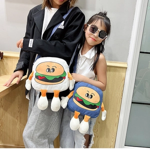 Detail of cartoon hamburger crossbody bags showing 3D arms and legs with canvas texture