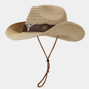Detailed close-up of straw cowboy hat featuring leather band and silver bull head emblem