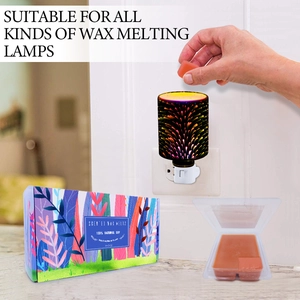Placing orange natural soy scented wax melt into a decorative electric wax warmer burner