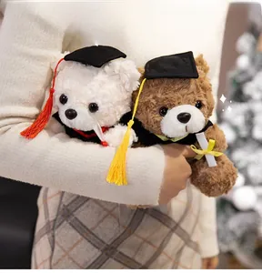 Close-up of plush graduation teddy bears in black gowns and caps being held