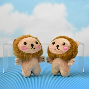 Detailed view of two cute lion plush keychains with fluffy brown manes