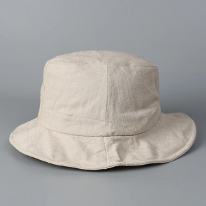 Close-up of beige linen sun hat fabric texture showing breathable cotton fiber weave