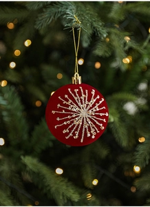 Detailed view of burgundy velvet Christmas ball with gold bead and sequin star embroidery