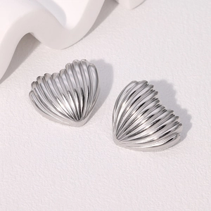 Minimalist silver heart stud earrings with vertical textured shell-like stripes