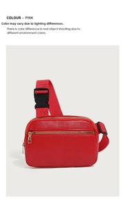Detail of red litchi texture leather waist bag with gold zippers and adjustable strap