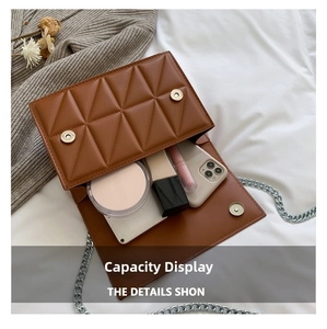 Interior view of brown quilted crossbody bag showing space for phone and cosmetics