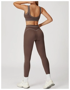 Rear view of high-waist chocolate brown yoga set with white contrast piping details