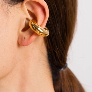 Detail of 18K gold-plated hammered hollow earring worn as a cuff by a female model