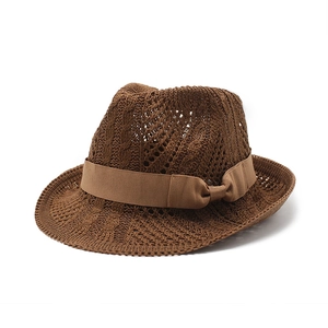 Dark brown knitted fedora with hollow crochet patterns and a satin ribbon bow