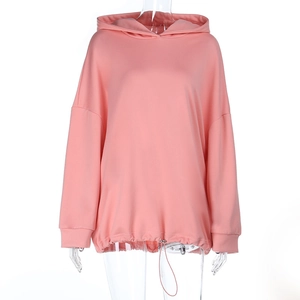 Detailed view of pink hoodie featuring adjustable drawstring hem and soft knit fabric