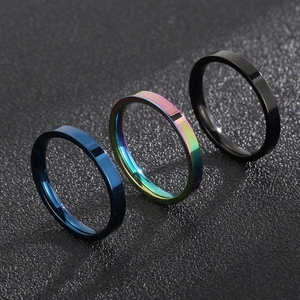 Three-piece stainless steel band rings in blue, rainbow, and black minimalist styles