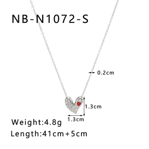 Detail view of silver heart pendant with red stone and dimensions 1.3cm x 1.3cm