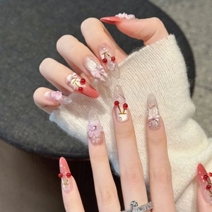 Elegante kersentuin stiletto kunstnagels met 3D bloemen en strik accenten.