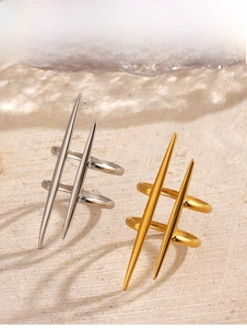 Detail showing punk style double-layered spiked rings in gold and silver steel finish