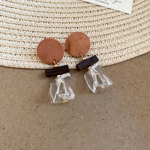 Detail of vintage 14K gold plated earrings with wood texture and resin pendants
