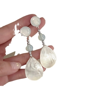Silver-tone teardrop resin earrings with mother-of-pearl texture and blue beads