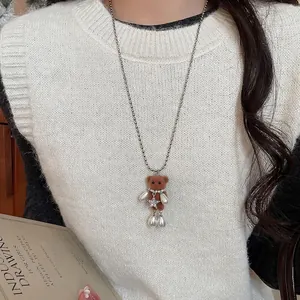 Brown flocked bear necklace with pearl details and star pendant on silver ball chain
