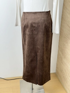 Detail of dark brown faux suede midi skirt showing back slit design and slim fit
