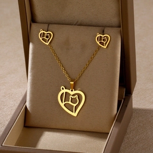Golden heart necklace and cat earring set in a premium velvet gift box display