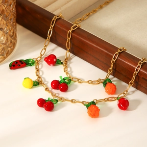 Gold stainless steel necklace featuring colorful resin fruit charms like cherry and strawberry
