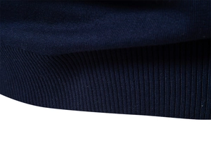 Macro shot of navy blue ribbed cuffs and textured knit fabric on a men's sweater