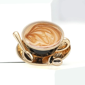 Detailed macro view of creative gold enamel coffee cup brooch with latte art pattern