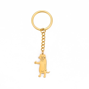 Gold stainless steel keychain with cute cartoon cat giving a thumbs up on white background