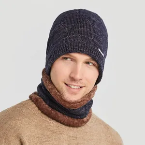 Winter set with dark blue knit beanie and fleece-lined neck warmer for cold weather
