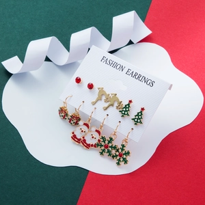 Detailed close-up of 6-piece Christmas earring set with Santa, deer and tree charms