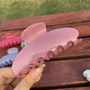 Sparkly pink acetate hair claw clip for women featuring a minimalist shark clip design