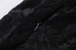 Detail of elegant black lace dress featuring a concealed zipper and floral texture