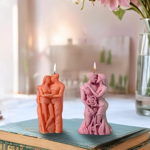 Detailed view of burning romantic couple embrace candle with rose floral textures