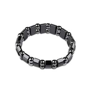 Detail shot of a black magnetic hematite bracelet featuring square and round metallic beads