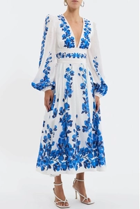 Detailed embroidery on a white floral maxi dress with deep V-neck and long lantern sleeves