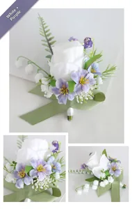 Detail view of wedding boutonniere with white rose, purple accents and green leaves