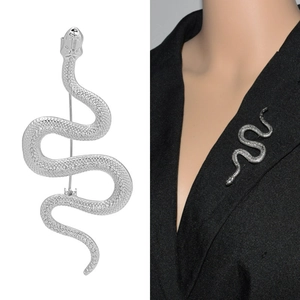 Detailed macro view and model shot of a silver textured snake brooch on a black suit blazer
