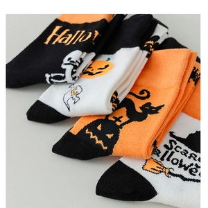 Close-up of stacked Halloween crew socks with pumpkin, ghost, and black cat patterns