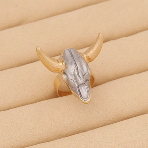 Macro view of bohemian bull skull ring with gold horns and vintage silver finish