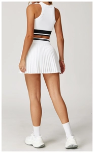 Rear view of white seamless tennis vest and pleated skirt set with black stripe details