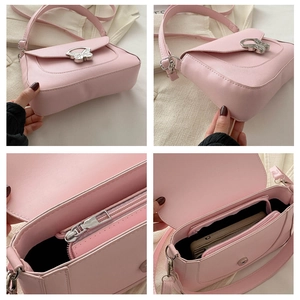 Detail of pink faux leather bag showing the butterfly metal clasp and interior pockets