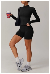 Detail of black quick-dry yoga set featuring a zip-up jacket and high-waisted shorts