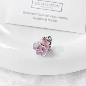 Detailed view of pink rose enamel charm with gold alloy trim for jewelry making