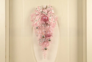 Detail of pink Christmas teardrop swag with silver bow and Merry Christmas sign