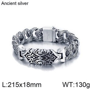 Detailed close-up of retro silver stainless steel bracelet with tribal carvings
