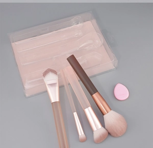 Detail of 4-piece makeup brush set with pink blending sponge in clear PVC box