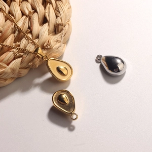18k gold and silver stainless steel avocado pendant necklaces on minimalist background
