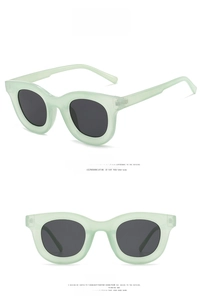 Front and side views of mint green sunglasses with round grey lenses and thick frames
