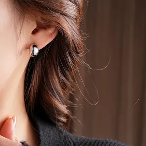 Polished silver pebble stud earrings with minimalist geometric design for women
