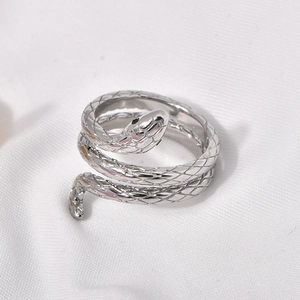 Macro detail of silver snake ring with scale texture and adjustable open band design