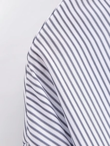 Detailed view of striped poplin shirt showing fine stitching and premium woven texture